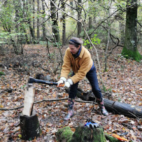 A woman chops wood