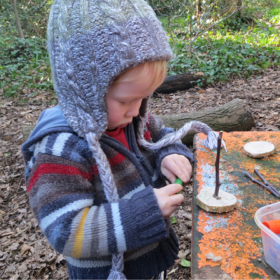 a small child plays with crafts outdoors